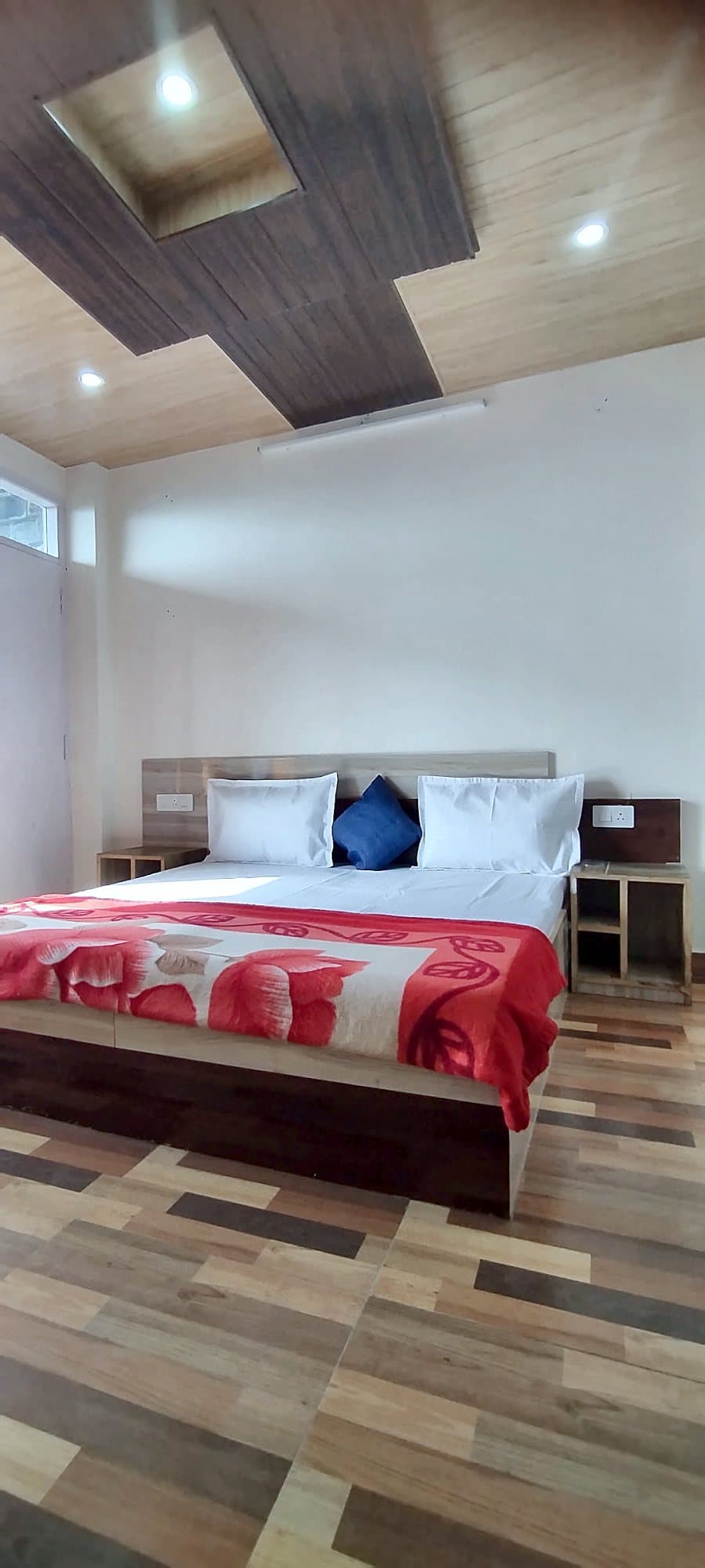Bedroom with a double bed and wooden floor at Pinewood
