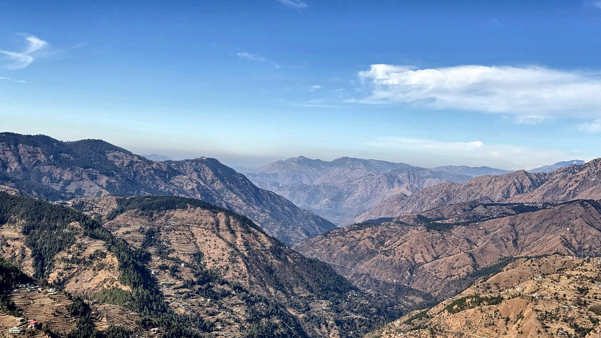 Mountain ridges and valleys around Kufri under a blue sky